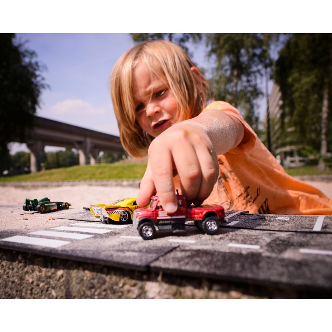 kid playing with toy car